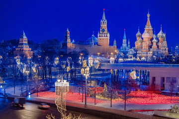 Fototapeta premium Moscow. Russia. Kremlin on Christmas night. St. Basil's Cathedral is a blessed view from afar. The road near the park is charging. Panorama of Moscow at night. New Year's capital Top view.