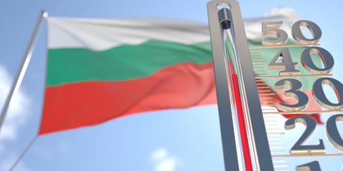 Thermometer shows high air temperature against blurred flag of Bulgaria. Hot weather forecast related 3D rendering