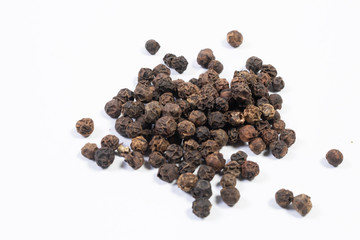 Whole black pepper, isolated on white.