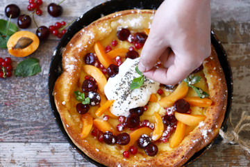 Selective focus. Dutch baby pancake. Healthy homemade dessert. Trend dessert with fruit.