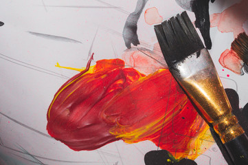 Paintbrush close up. drawing process. paint stains on the paper