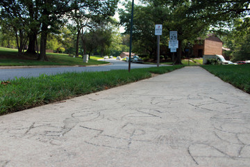 Carvings in ground with speed limit sign