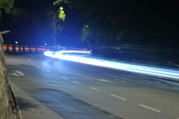 Long exposure shot of a car on the road at night