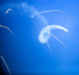 Condensation marks on the blue sky from jet planes.