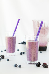 Glasses of freshly blended berry smoothie ready for drinking.