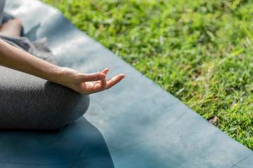 Healthy women doing yoga in the moring at the park . concept healthy and outdoor activity.