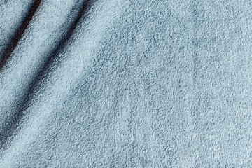 Top view from the top of a light blue towel with two wrinkles