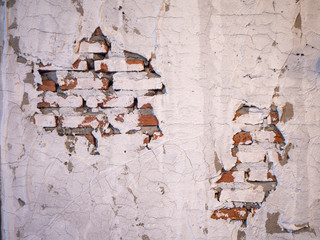 Old brick wall with peeling plaster for background