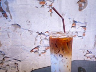 Iced latte coffee glass on wooden table