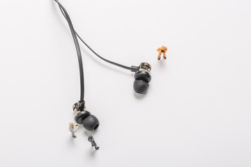 Headphones and miniature workers on white background