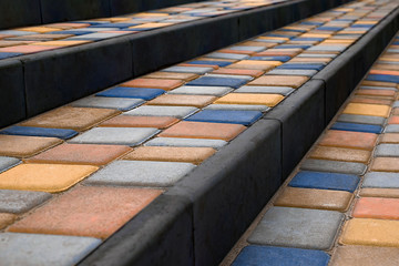 Stairs covered colorful paving slabs. Perspective view