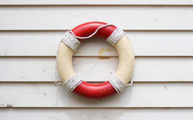 Decorative life preserver on rustic weather board wall