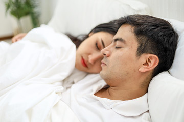 Fototapeta na wymiar Happiness young couple lover sleeping and relaxation on bedroom.
