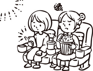 映画上映中にスマートフォンを見る女性