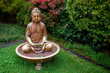 Buddha fountain in garden.