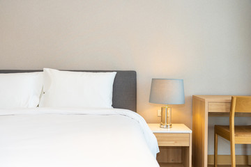 White pillow on bed decoration interior of bedroom interior with light lamp