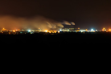Naklejka na ściany i meble Night view of industrial district of the city and smoke pipes of factory