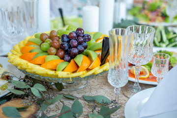 Tasty dishes on a served white banquet table in a luxury restaurant.