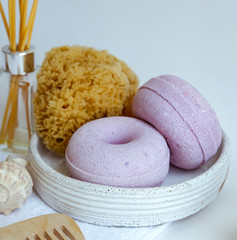 spa composition soap with salt bombs on a pink background, the concept of relaxation and body care