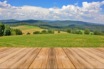 Wooden table top with summer mountain landscape. Beautiful view on Low Beskids (Beskid Niski), Poland - obrazy, fototapety, plakaty