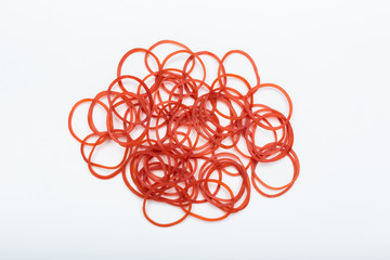 Red rubber bands on white background. Isolated rubber band. Pile of rubber bands.
