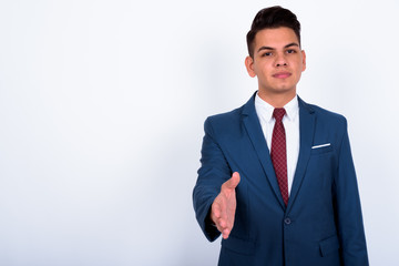 Portrait of young handsome multi ethnic businessman in suit
