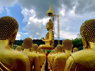 Many monks' statues and Buddha make prayers in Makha Bucha Buddhist Memorial Park,Thailand