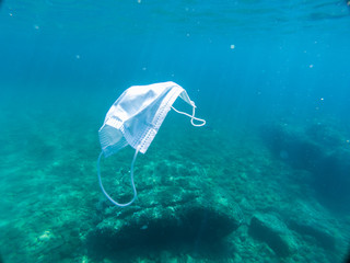 Disposable protection mask under the sea, residues of the covid-19 pandemic

