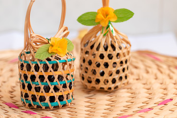 Close up view. Original Thai dessert in binding bamboo fraction. And weave them into coil with small basket for carrying.