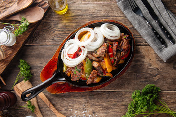 Baked beef with vegetables in cast iron pan