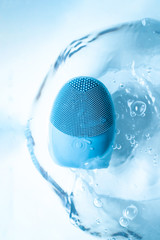 Skin massager in pure water in blue colors. Home wellness concept. Skin care