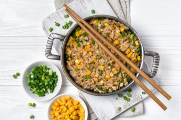 A traditional vegetarian dish of Asian cuisine. Rice with green onion and yellow corn