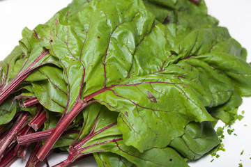 Leaves of beet tops on the table surface. Taken in close-up .