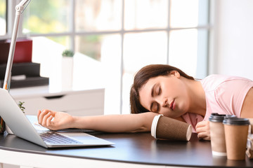 Tired student sleeping at table