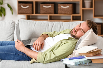 Tired male student sleeping at home