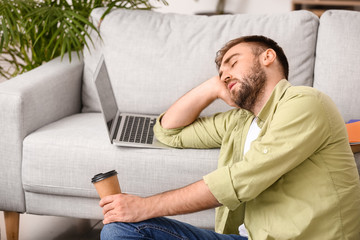 Fototapeta premium Tired male student sleeping at home