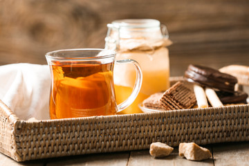 Cup of hot tea and honey on table