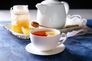 Cup of hot tea on table