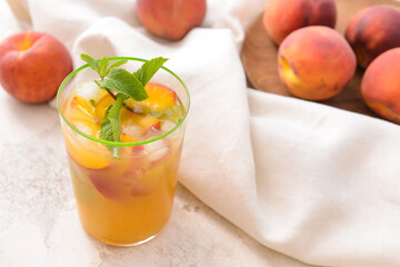 Glass of tasty peach juice on white background