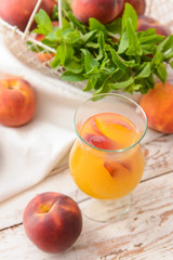 Glass of tasty peach juice on table