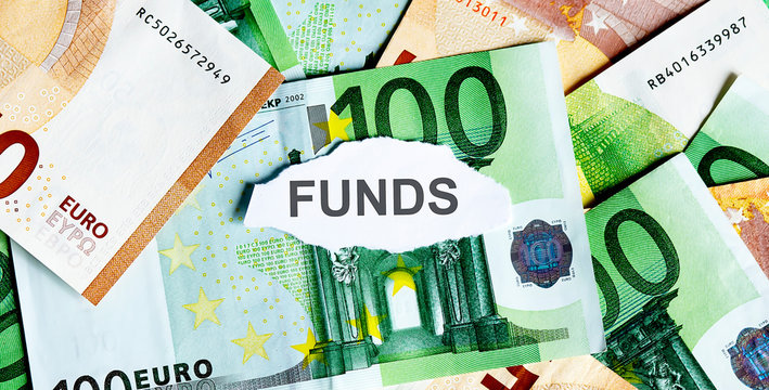 Focus on the word FUNDS on piece of torn white paper with EUROS currency as a background.