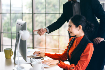 Adult asian business people work together in office.