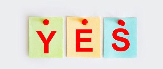 YES phrase is written on multi-colored stickers, on the white background. Business concept, strategy, plan