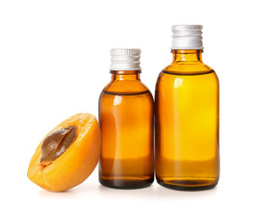 Bottles of apricot essential oil on white background