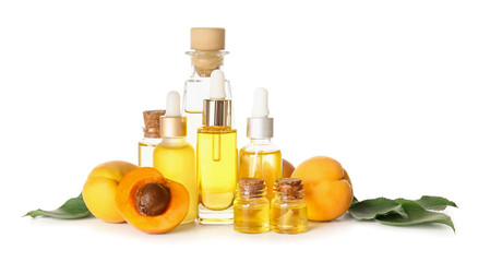 Bottles of apricot essential oil on white background