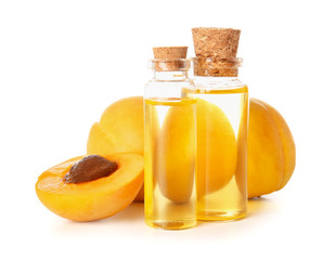 Bottles of apricot essential oil on white background