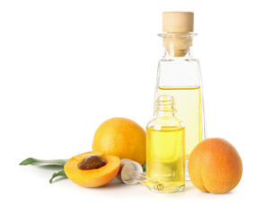 Bottles of apricot essential oil on white background