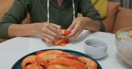 Woman eat shrimp at home