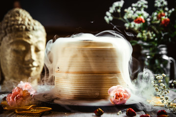 Asian bamboo steamer on the decorated table