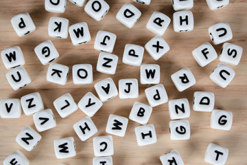 Text dice cube concept / Letter dices alphabet on wooden background. Block of alphabet studded on the floor.